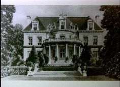 an old black and white photo of a large house