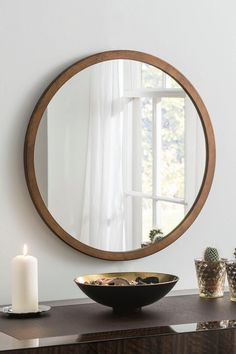 a table with a bowl and candle on it