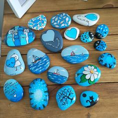 painted rocks are arranged on a wooden table