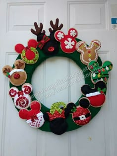 a christmas wreath made out of felt with mickey mouses and other holiday decorations on it