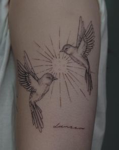 two birds flying in the sky with sunbursts on their wings tattoo design