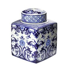 a blue and white vase with an intricate design on the top, sitting in front of a white background