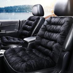 the interior of a car with black leather seats and steering wheel covers, along with a lake in the background