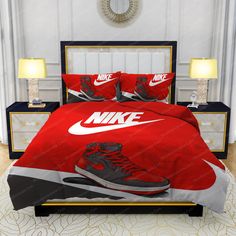 a bed with a pair of nike sneakers on it and two lamps in the corner