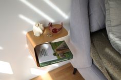 a small table with a book on it next to a couch