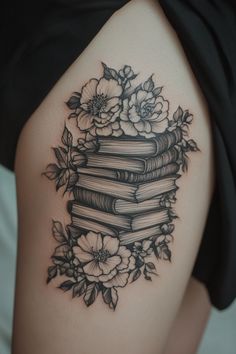 a woman's thigh with flowers and books on it