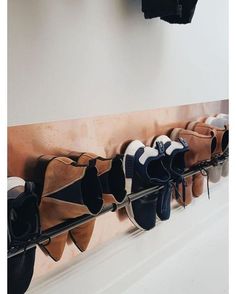 there are many pairs of shoes hanging on the wall