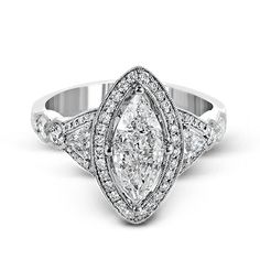 a white gold ring with three pear shaped diamonds on the sides and an intricate band