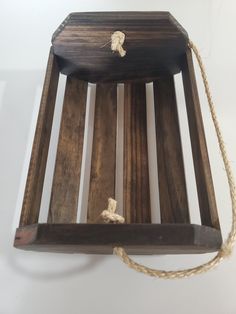 a piece of wood with rope hanging from it