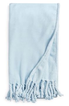 a light blue blanket with fringes on it