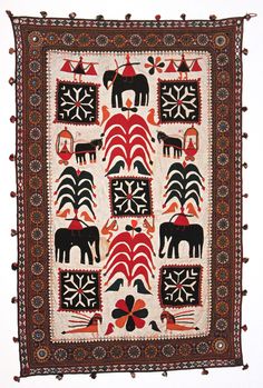 an embroidered wall hanging with horses on it