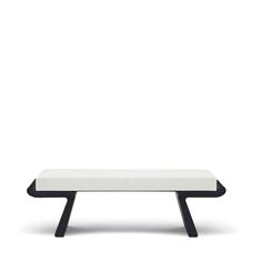 a white bench with black legs on a white background