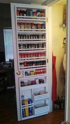 the pantry door is open to show what's inside it and how many items are stored