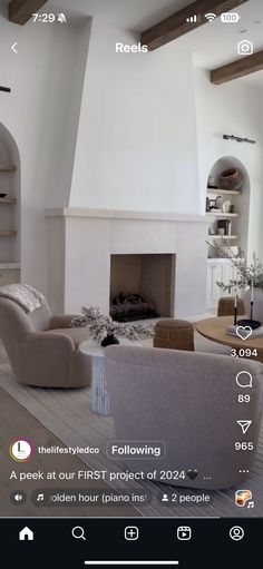 a living room filled with furniture and a fire place in front of a white fireplace