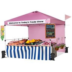 a pink and blue striped tent with food on it that says welcome to today's trade show