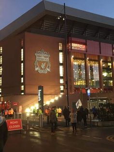 people are standing outside the stadium at night