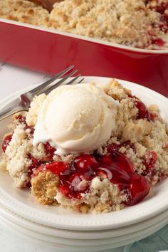 a white plate topped with ice cream next to a red casserole dish filled with dessert