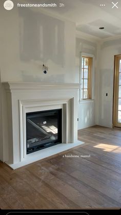 an empty living room with white walls and wood flooring is seen in this image