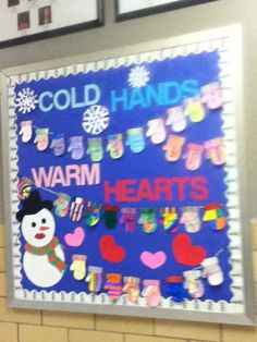 a bulletin board with cold hands and warm hearts attached to the front wall in a classroom