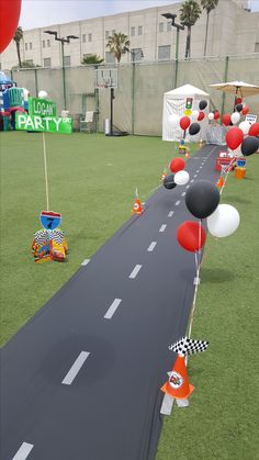 balloons and streamers are on the side of an empty road