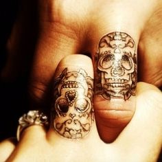 two fingers that have tattoos on them