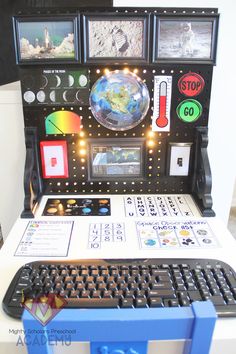 a computer keyboard sitting on top of a white desk next to a monitor and mouse