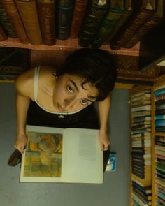 a woman looking up at an open book