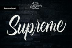 the word supreme is written in white on a black brick wall