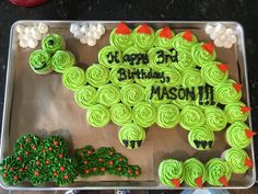 a birthday cake with green frosting and decorations