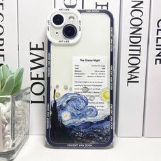 the starry night phone case is next to a vase with flowers and books on it