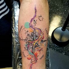 a person with a compass tattoo on their arm