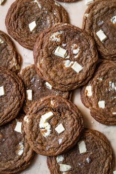 a pile of cookies with white cheese on top