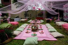 a table set up with pink and green decorations