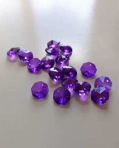 purple crystals are scattered on a white surface