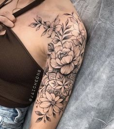 a woman with a flower tattoo on her arm