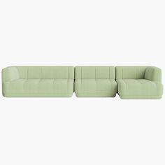 a green couch sitting on top of a white floor