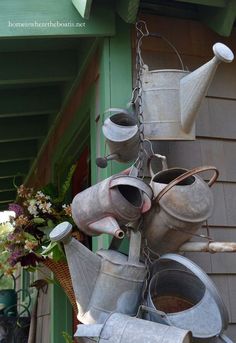 pots and pans are hanging from the side of a house