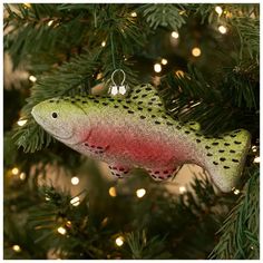 a fish ornament hanging from a christmas tree