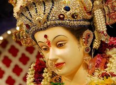 a close up of a person wearing a costume and headdress with flowers on it