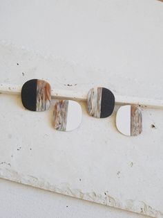 three pieces of wood sitting on top of a white wall