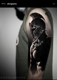 a man's arm with a black and white tattoo design on the left shoulder