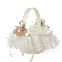 a white flower girl basket with pearls and lace