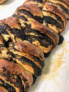 there are many different types of breads on the table together and one has chocolate frosting