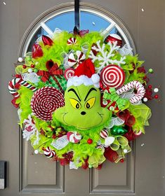 the grinch wreath is hanging on the front door