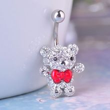 a small teddy bear with a red bow tie belly button navel barbell ring