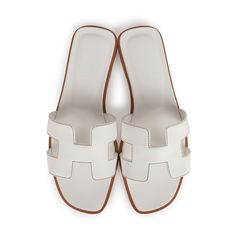 This pair of Oran Sandals are in white box leather with contrast stitching and feature the iconic H crossover strap. Origin: ItalyCondition: New and never wornAccompanied by: Hermes box, dustbags, carebook and ribbonSize: 37 EU White Hermes Oran, White Hermes Sandals, Hermes Slippers, Hermes Sandals, Hermes Oran Sandals, Hermes Birkin 25, Hermes Shoes, Girl Closet, Hermes Box