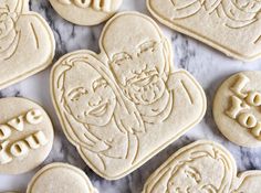 some cookies that have been decorated to look like jesus and the word love is spelled on them