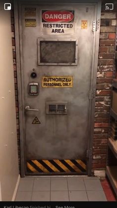 an industrial door with warning signs on the front and side panels that read danger restricted area