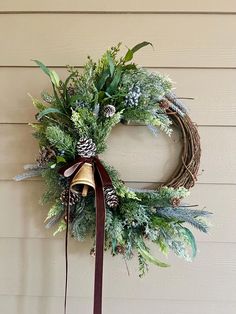 This crescent style wreath features mixed frosted greenery, berries, a large gold bell and a velvet bow. Choose your ribbon color at checkout.  Hang this winter wreath on your door or in your home now until spring!  This wreath is constructed on a 14 inch grapevine base and measures approximately 20 inches tall and 16 inches wide.  All my wreaths are packaged with care so they get to you safely.  For other available listings, please visit: www.emilysartisanwreaths.Etsy.com Crescent Wreath, Natural Wreaths, Dried Floral Wreaths, Winter Greenery, Winter Wreaths, Natural Wreath, Door Wreaths Diy