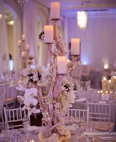 an image of a table setting with candles and flowers on it for a wedding reception